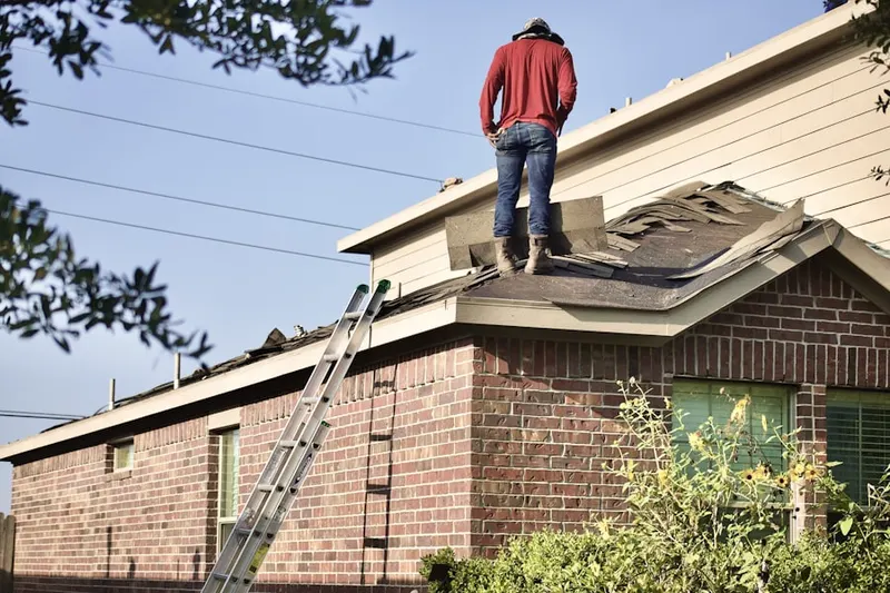 Professional roofer working on a residential roof in Myford